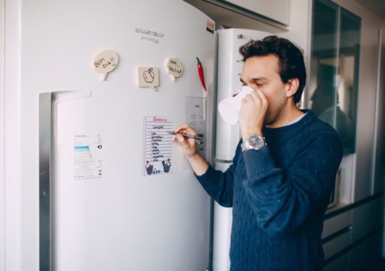 editing a shopping list on a fridge