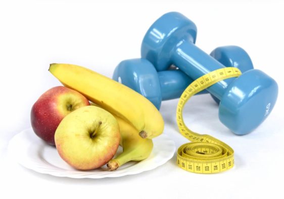 apples banana measuring tape and a dumbbell
