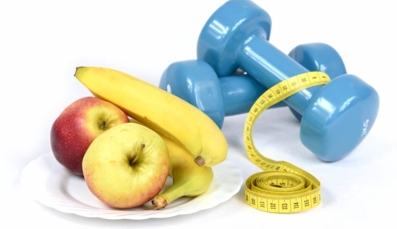 apples banana measuring tape and a dumbbell