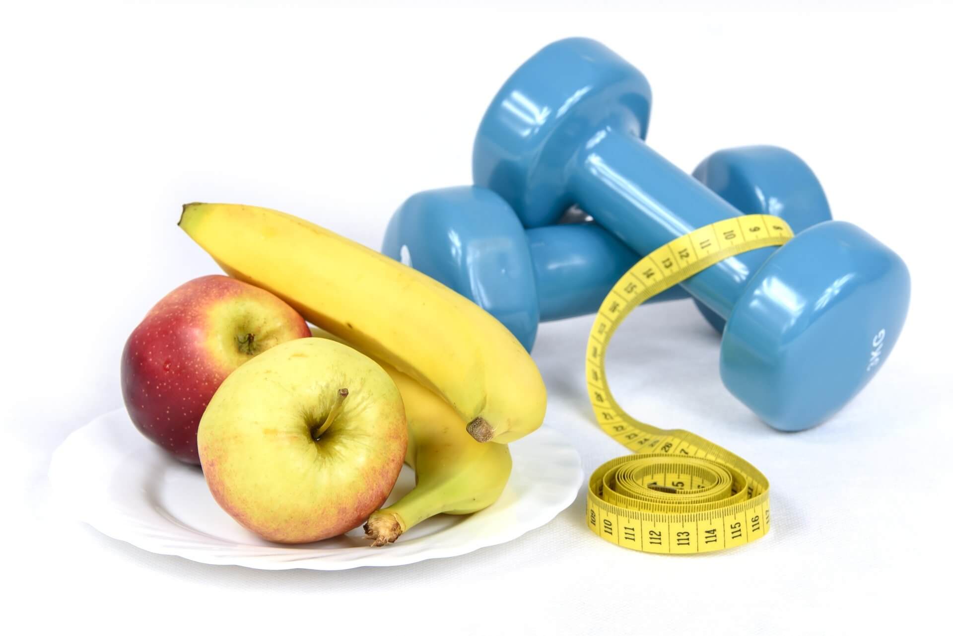 apples banana measuring tape and a dumbbell