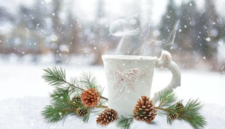 cup of hot drink in winter snow