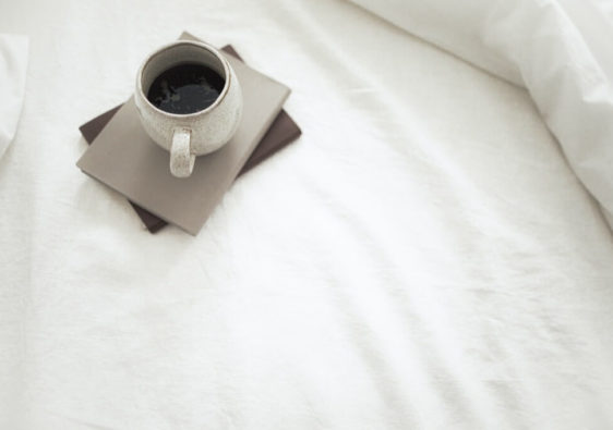 cup of black coffee in bed