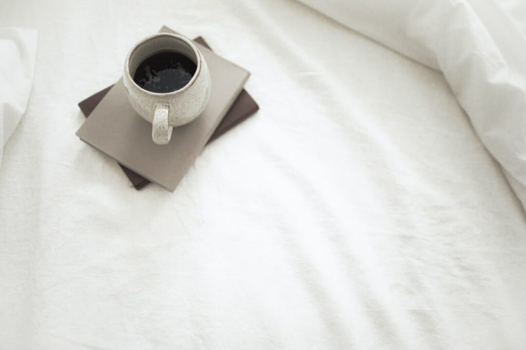 cup of black coffee in bed